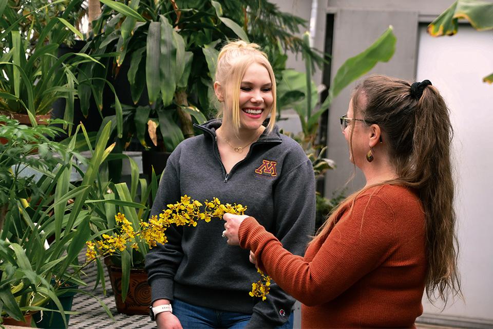 Theresa Helegeson, Horticulture instructor working with female student in the greenhouse